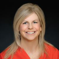 Headshot of Julie Williams on black background