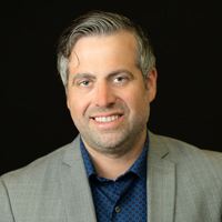 Headshot of Andy Gitzlaff on black background