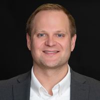 Headshot of person on black background