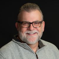 Headshot of person on black background