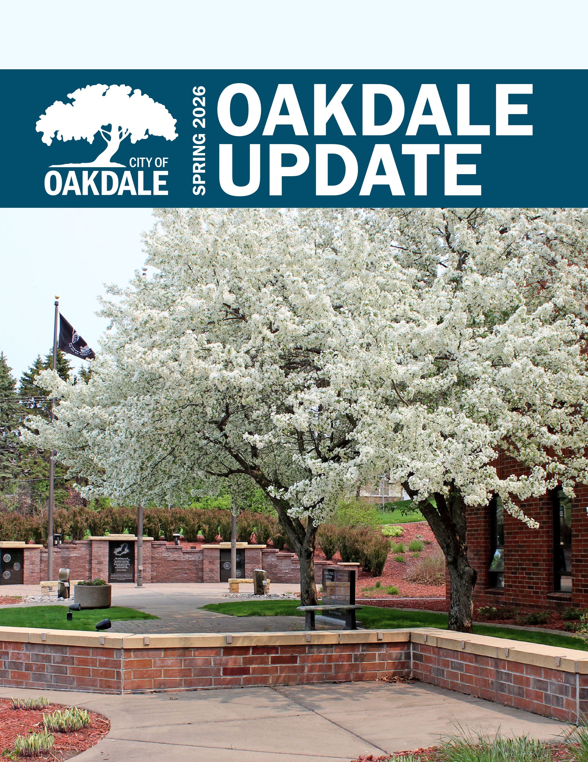 cover of a newsletter with image of white flowering trees with brick memorial, text "OAKDALE UPAD